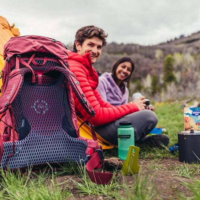 two people camping with backpacks